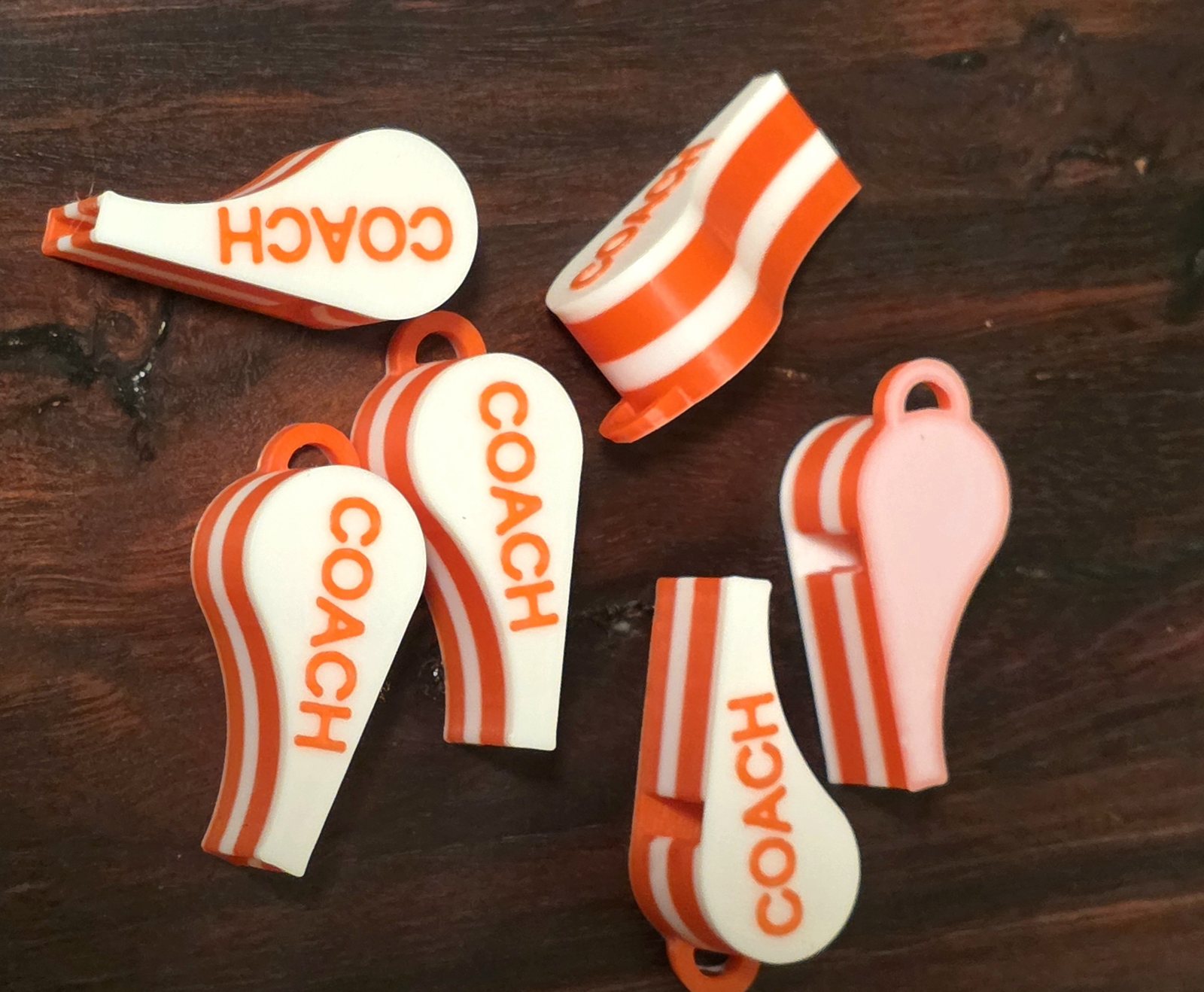 Orange and white personalised coach whistles